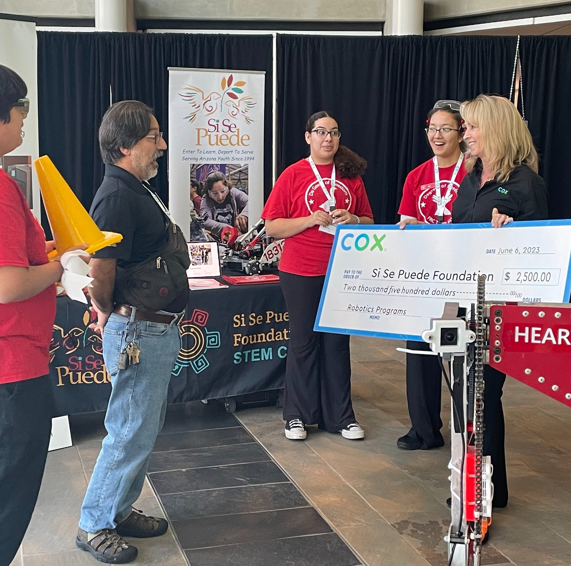 Cox presenting a check to non-profit organization during Smarter Arizona event. 