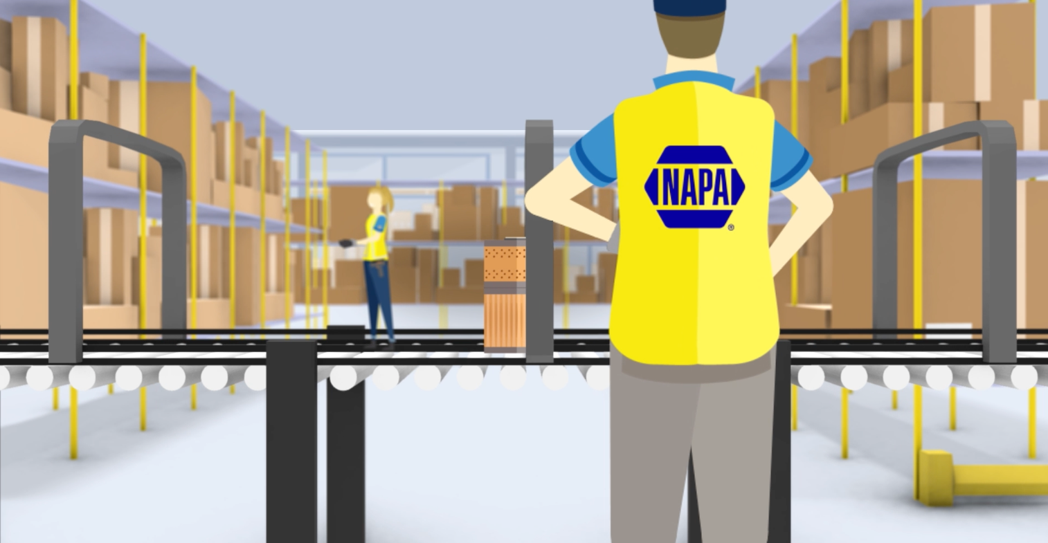 Video still of Napa video showing an employee standing in front of a conveyor belt