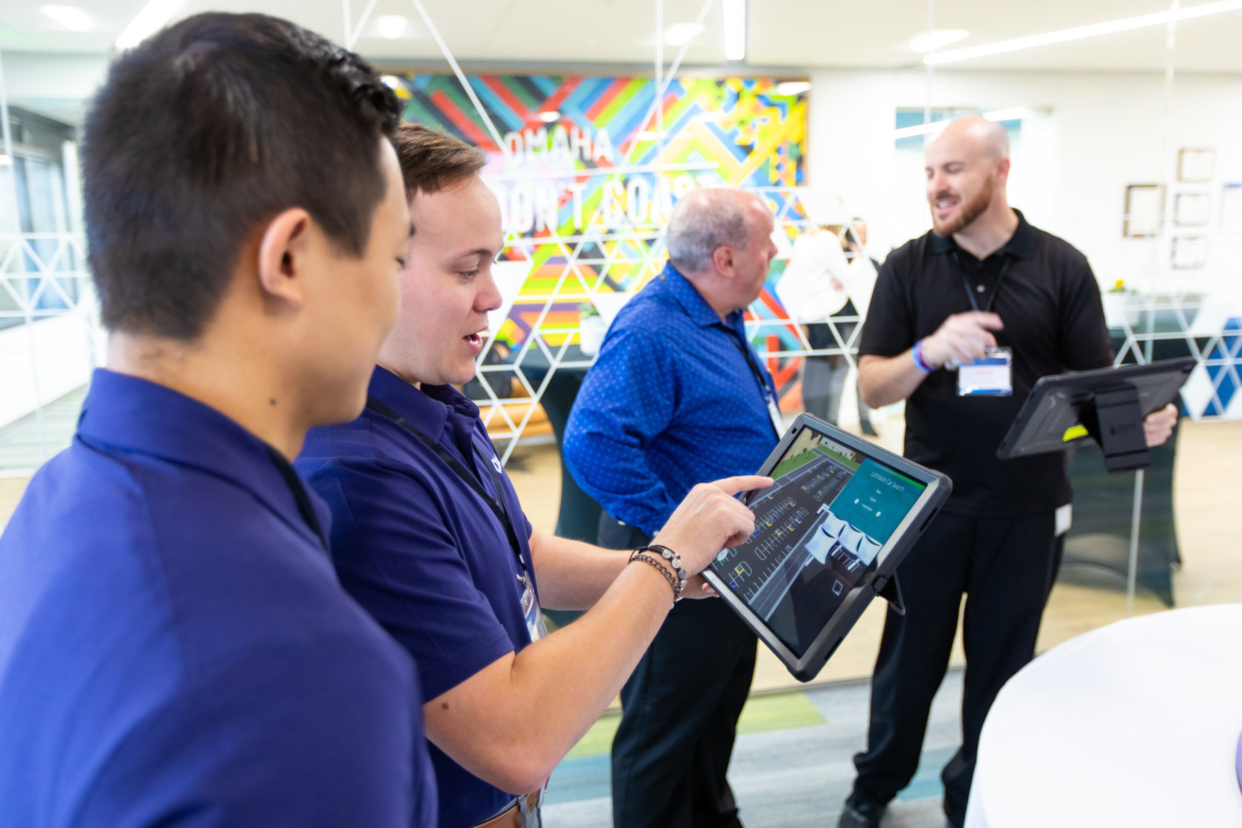 Participants interacting with new technology during Cox's executive leadership meeting. 